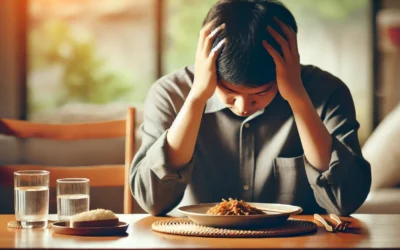 A person holding their head at the dining table, symbolizing headache after eating.